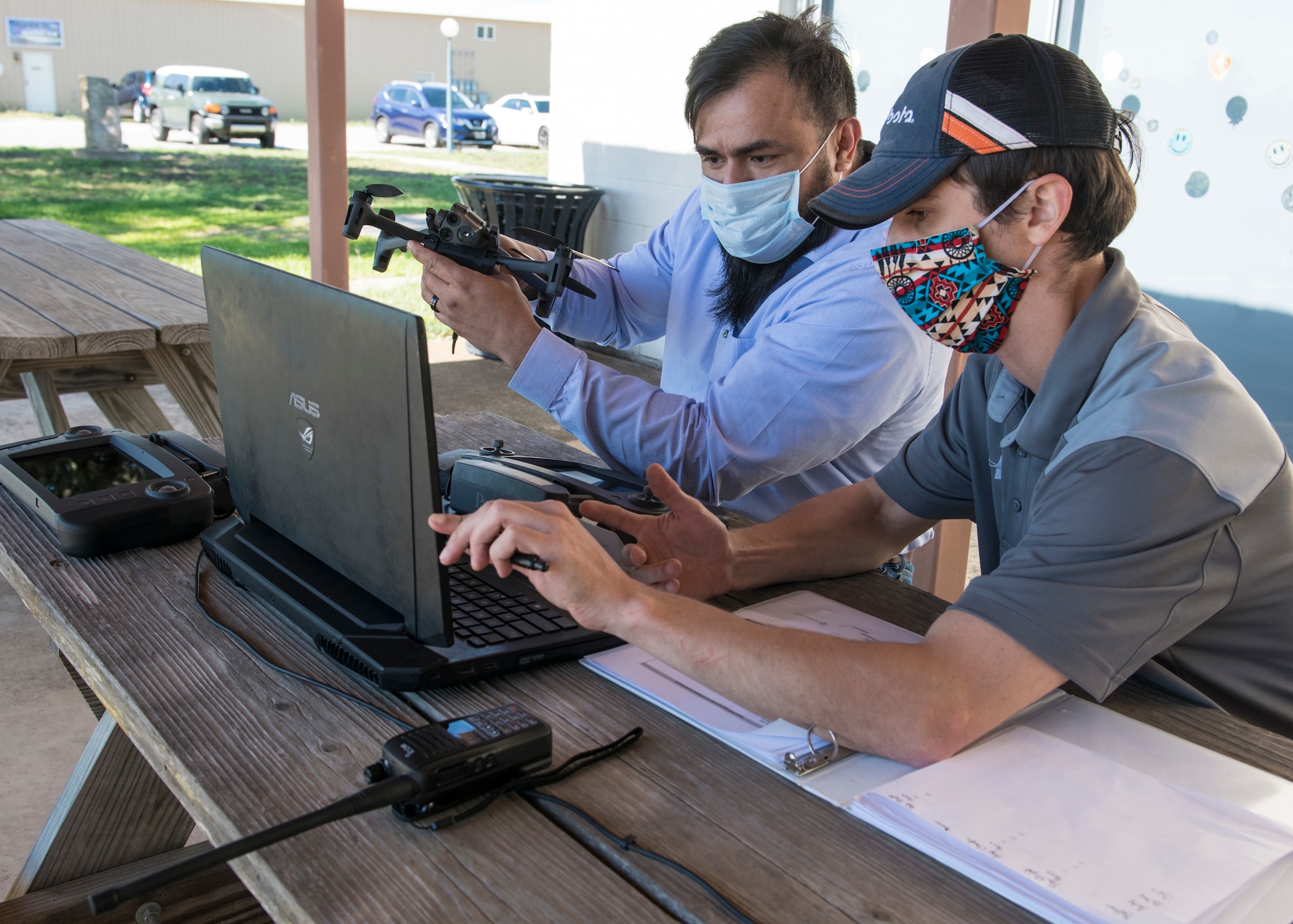 Julio Toala, Air Force Civil Engineer Center GeoBase program geospatial operations manager, receives training from Joseph Campbell, Emerging Technologies Institute chief technology officer and lead instructor, on drone pre-flight checks at San Geronimo Air Park, Texas, May 7, 2021. The training focused on pre- and post-flight checks, projecting flight patterns and 3D mapping using images from the drone. The Air Force GeoBase mission is to create and exploit geospatial information and services to optimize agile combat support and minimize operational risk.