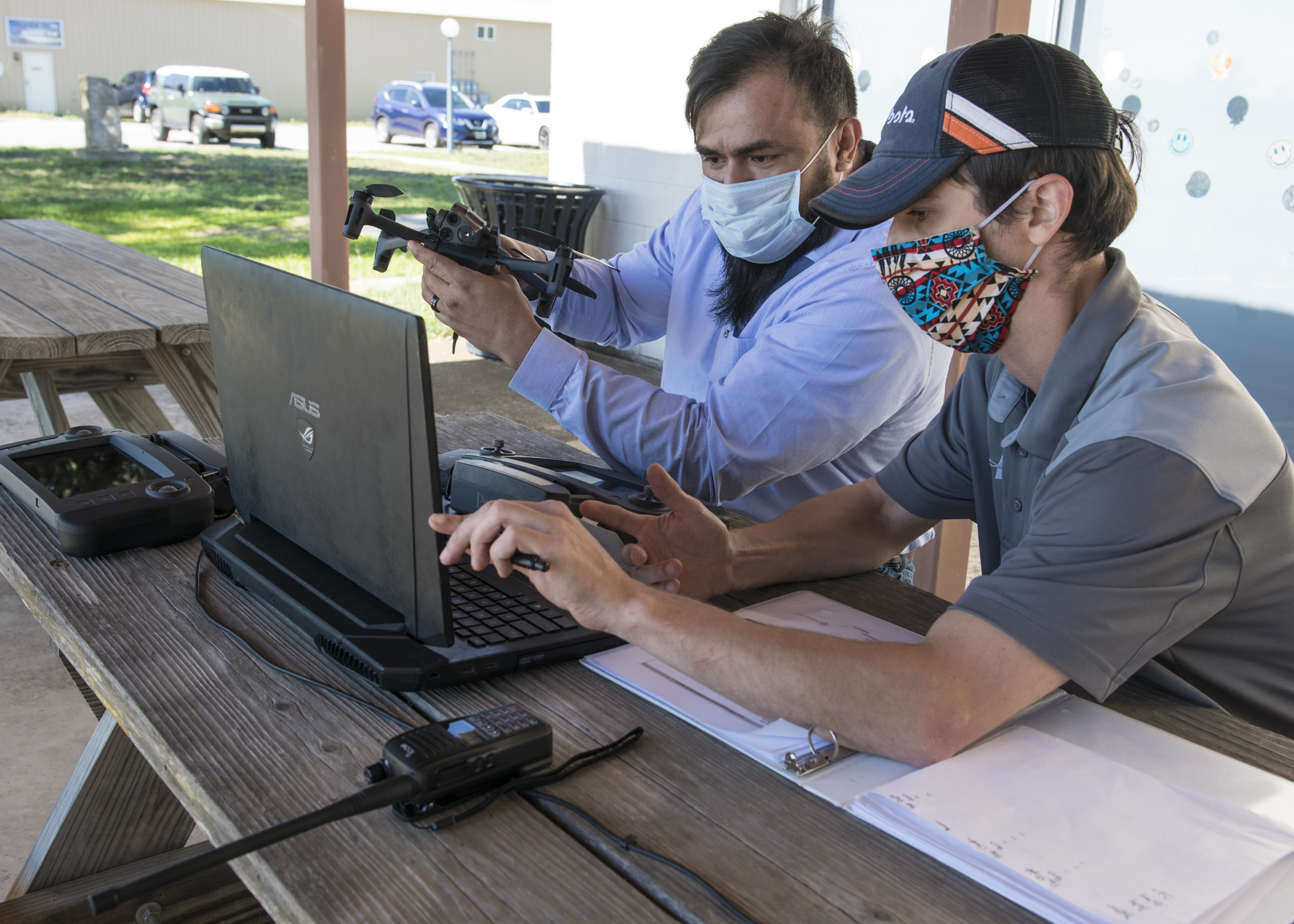 Julio Toala, Air Force Civil Engineer Center GeoBase program geospatial operations manager, receives training from Joseph Campbell, Emerging Technologies Institute chief technology officer and lead instructor, on drone pre-flight checks at San Geronimo Air Park, Texas, May 7, 2021. The training focused on pre- and post-flight checks, projecting flight patterns and 3D mapping using images from the drone. The Air Force GeoBase mission is to create and exploit geospatial information and services to optimize agile combat support and minimize operational risk.