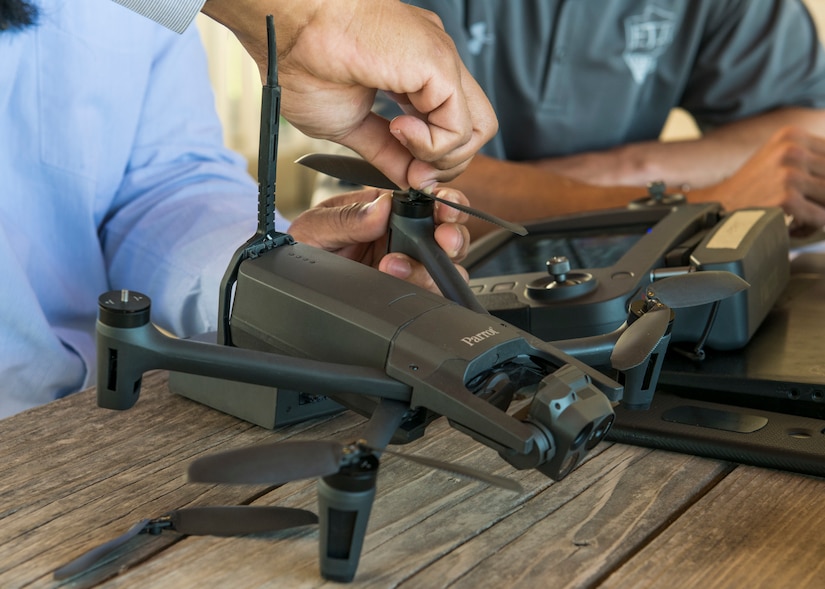 The student inspects and changes out propellers on a drone during pre-flight checks during Air Force Civil Engineer Center GeoBase program drone training at San Geronimo Air Park, Texas, May 7, 2021. The training focused on pre- and post-flight checks, projecting flight patterns and 3D mapping using images from the drone. The Air Force GeoBase mission is to create and exploit geospatial information and services to optimize agile combat support and minimize operational risk.