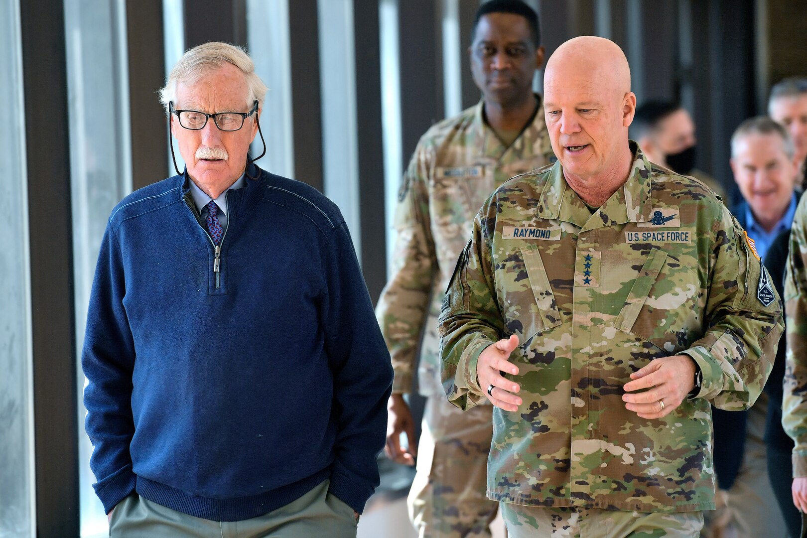 Military members brief senator in walkway