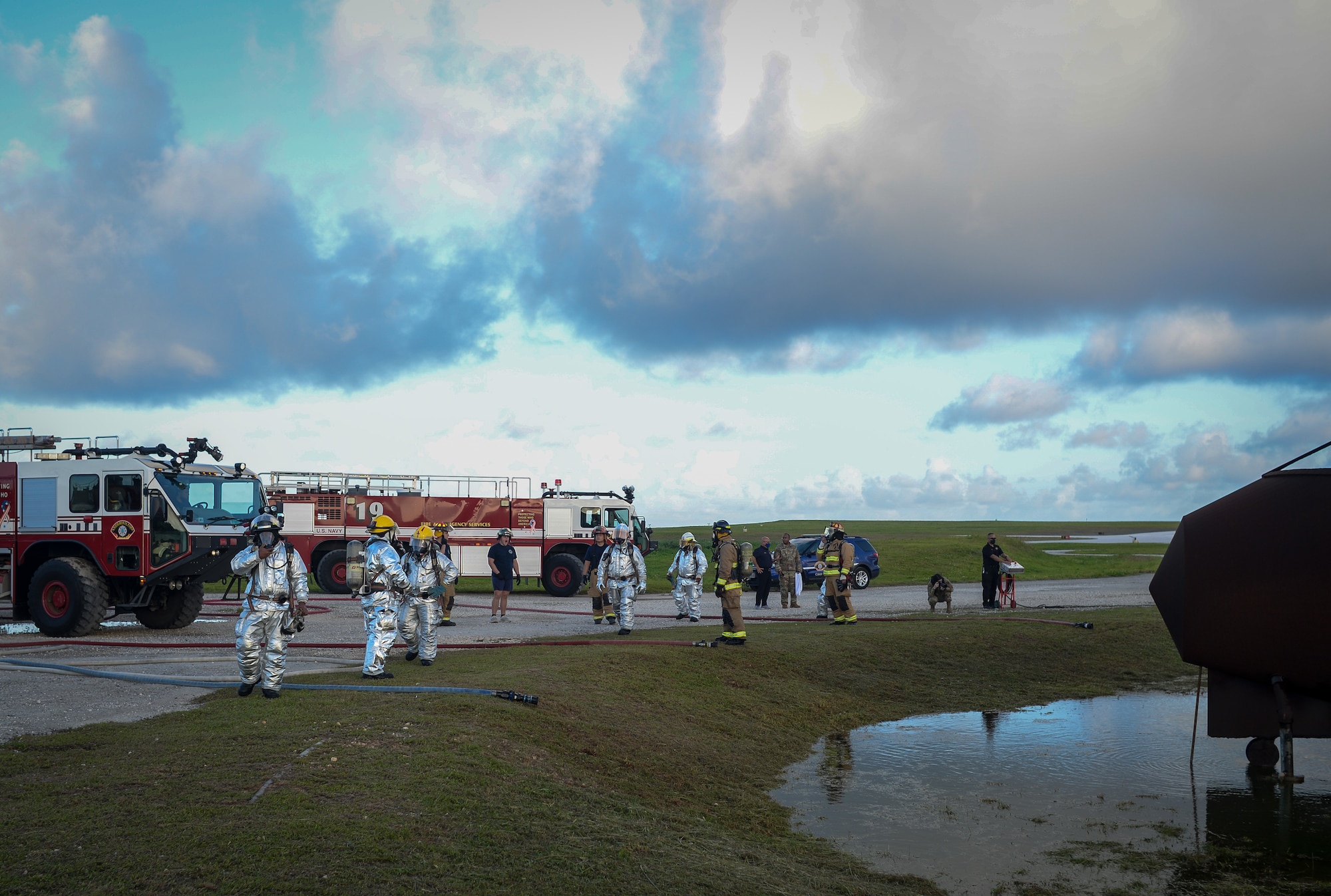 U.S. Air Force and Palau firefighters prepare fire hoses during joint aircraft fire training at Andersen Air Force Base, Guam, May 11, 2021.