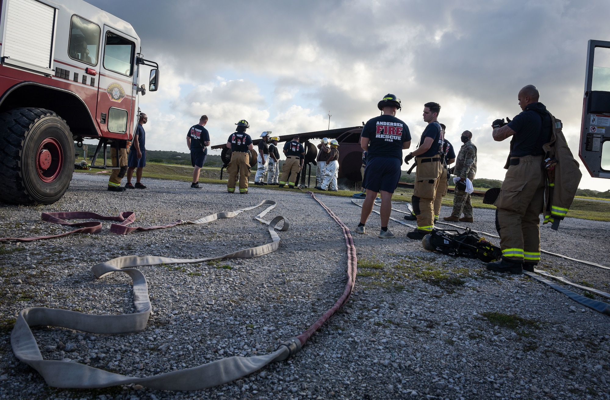 U.S. Air Force and Palau firefighters prepare fire hoses during joint aircraft fire training at Andersen Air Force Base, Guam, May 11, 2021.
