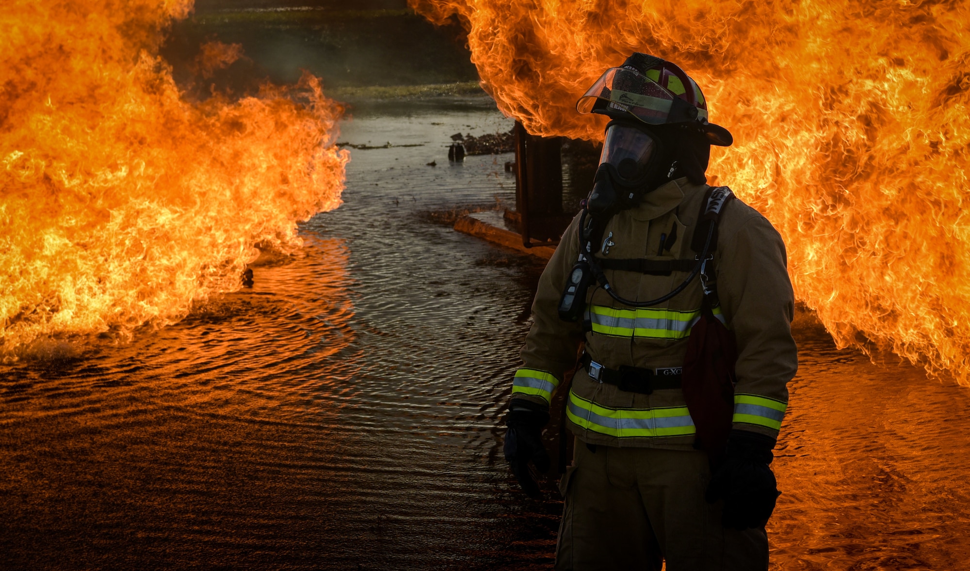 U.S. Air Force Tech. Sgt. Jordan Salas, firefighter assigned to the 36th Civil Engineer Squadron, looks on at a burning aircraft during joint aircraft fire training at Andersen Air Force Base, Guam, May 11, 2021.