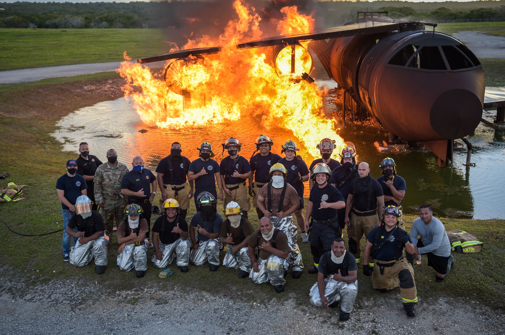 U.S. Air Force and Palau firefighters pose for a picture during joint aircraft fire training at Andersen Air Force Base, Guam, May 11, 2021.