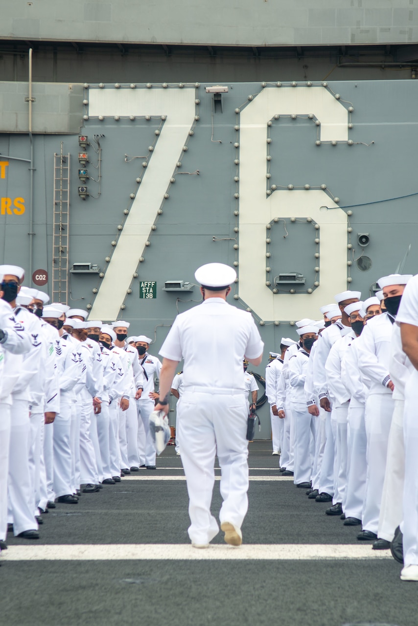 210519-N-LI114-1017 YOKOSUKA, Japan (May 19, 2021) Sailors prepare to man the rails on the flight deck of the U.S. Navy’s only forward-deployed aircraft carrier USS Ronald Reagan (CVN 76) as it departs Commander, Fleet Activities Yokosuka, Japan. Ronald Reagan, the flagship of Carrier Strike Group Five, provides a combat-ready force that protects and defends the United States, as well as the collective maritime interests of its allies and partners in the Indo-Pacific region. (U.S. Navy Photo by Mass Communication Specialist 3rd Class Michael B. Jarmiolowski)