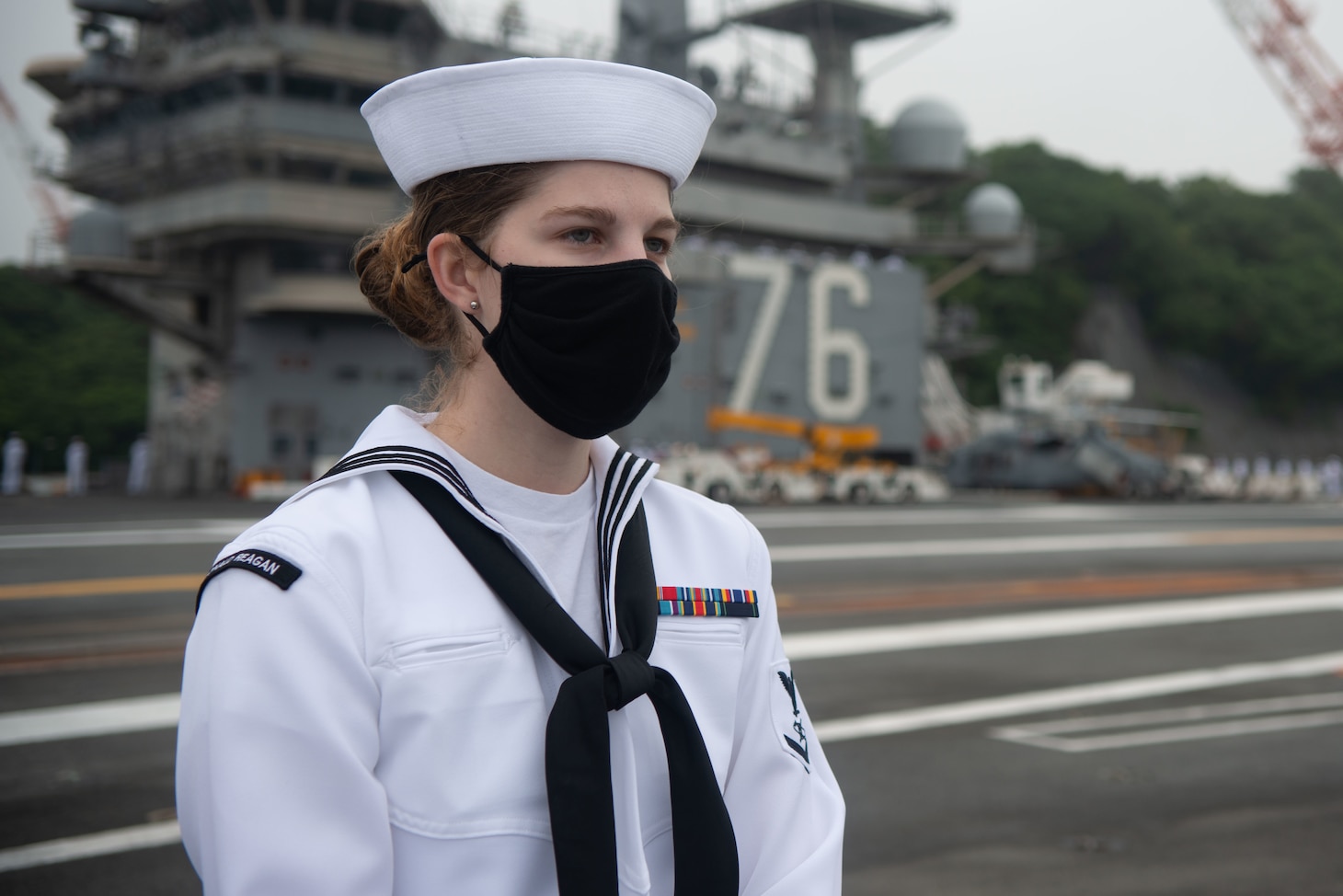 210519-N-LI114-1047 YOKOSUKA, Japan (May 19, 2021) Mass Communication Specialist 3rd Class Jillian Grady, from Waretown, New Jersey mans the rails on the flight deck of the U.S. Navy’s only forward-deployed aircraft carrier USS Ronald Reagan (CVN 76) as it departs Commander, Fleet Activities Yokosuka, Japan. Ronald Reagan, the flagship of Carrier Strike Group Five, provides a combat-ready force that protects and defends the United States, as well as the collective maritime interests of its allies and partners in the Indo-Pacific region. (U.S. Navy Photo by Mass Communication Specialist 3rd Class Michael B. Jarmiolowski)
