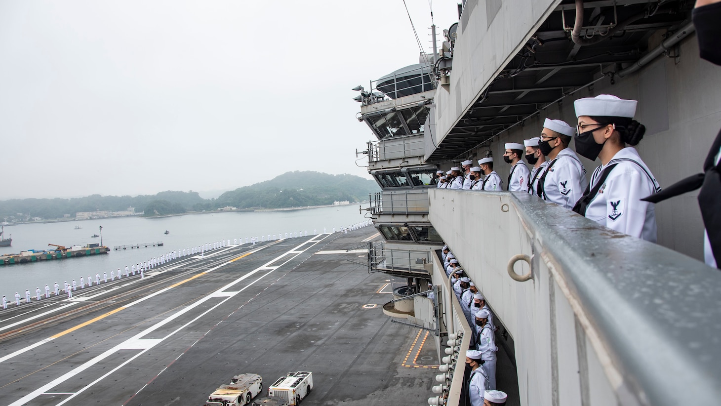 210519-N-WS494-1108 YOKOSUKA, Japan (May 19, 2021) Sailors man the rails aboard the U.S. Navy’s only forward-deployed aircraft carrier USS Ronald Reagan (CVN 76) as it departs Commander, Fleet Activities Yokosuka, Japan. Ronald Reagan, the flagship of Carrier Strike Group Five, provides a combat-ready force that protects and defends the United States, as well as the collective maritime interests of its allies and partners in the Indo-Pacific region. (U.S. Navy photo by Mass Communication Specialist 3rd Class Quinton A. Lee)