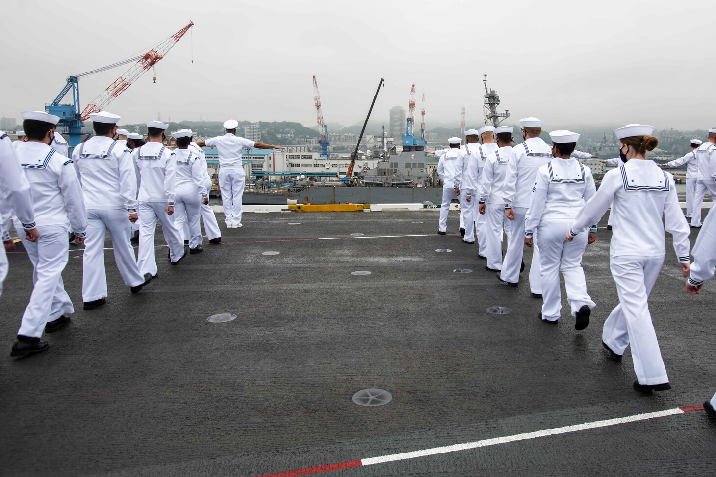 210519-N-WU964-1071 YOKOSUKA, Japan (May 19, 2021) Sailors man the rails on the flight deck of the U.S. Navy’s only forward-deployed aircraft carrier USS Ronald Reagan (CVN 76) as it departs Commander, Fleet Activities Yokosuka, Japan. Ronald Reagan, the flagship of Carrier Strike Group 5, provides a combat-ready force that protects and defends the United States, as well as the collective maritime interests of its allies and partners in the Indo-Pacific region. (U.S. Navy photo by Mass Communication Specialist Seaman Apprentice Dallas Snider)