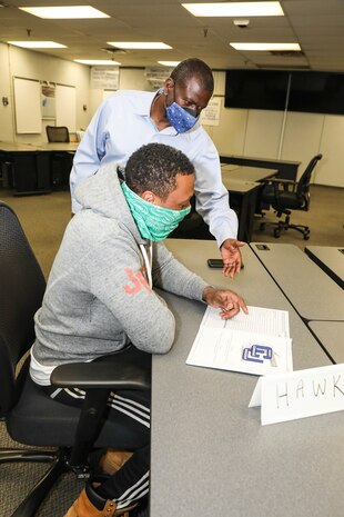 Command University's (CU) (Code 900CU) Management and Program Analyst Turner Anthony instructs Lifting and Handling (Code 740) Rigger Leader (Shop 72) Britton Williams Hawkins during CU's new High Velocity Work Leader course.