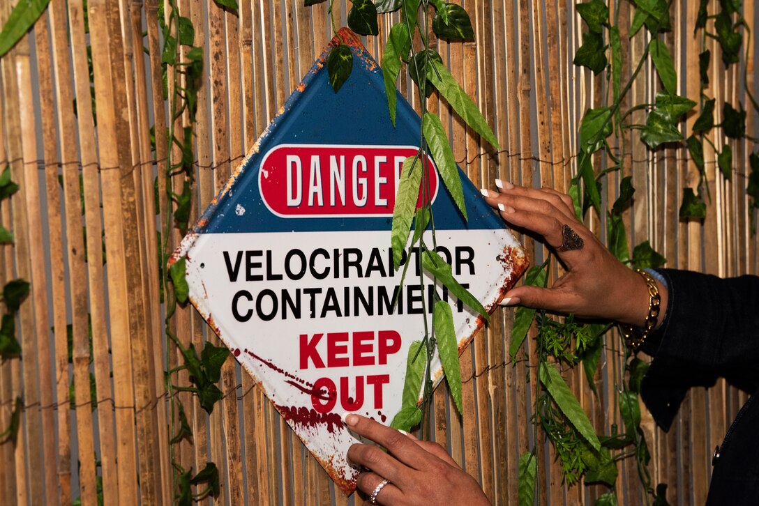 Cherie Elliott, the Wing Chaplain's wife, handles a piece of décor in one of the two escape rooms at Spangdahlem Air Base, Germany, May 14, 2021. The rooms, which open to the public May 24, are scheduled to have various time slots to accommodate the different shifts that Airmen work. (U.S. Air Force photo by Tech. Sgt. Tony Plyler)
