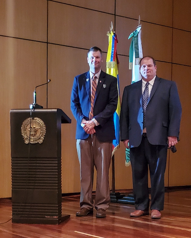 Joseph Kidwell Jr., left, the Senior Central Case Manager, and Jason King, the Country Program Manager, both from U.S. Army Security Assistance Command, pose for a photo after a training class at the Colombian National Police headquarters, in Bogota, Colombia.