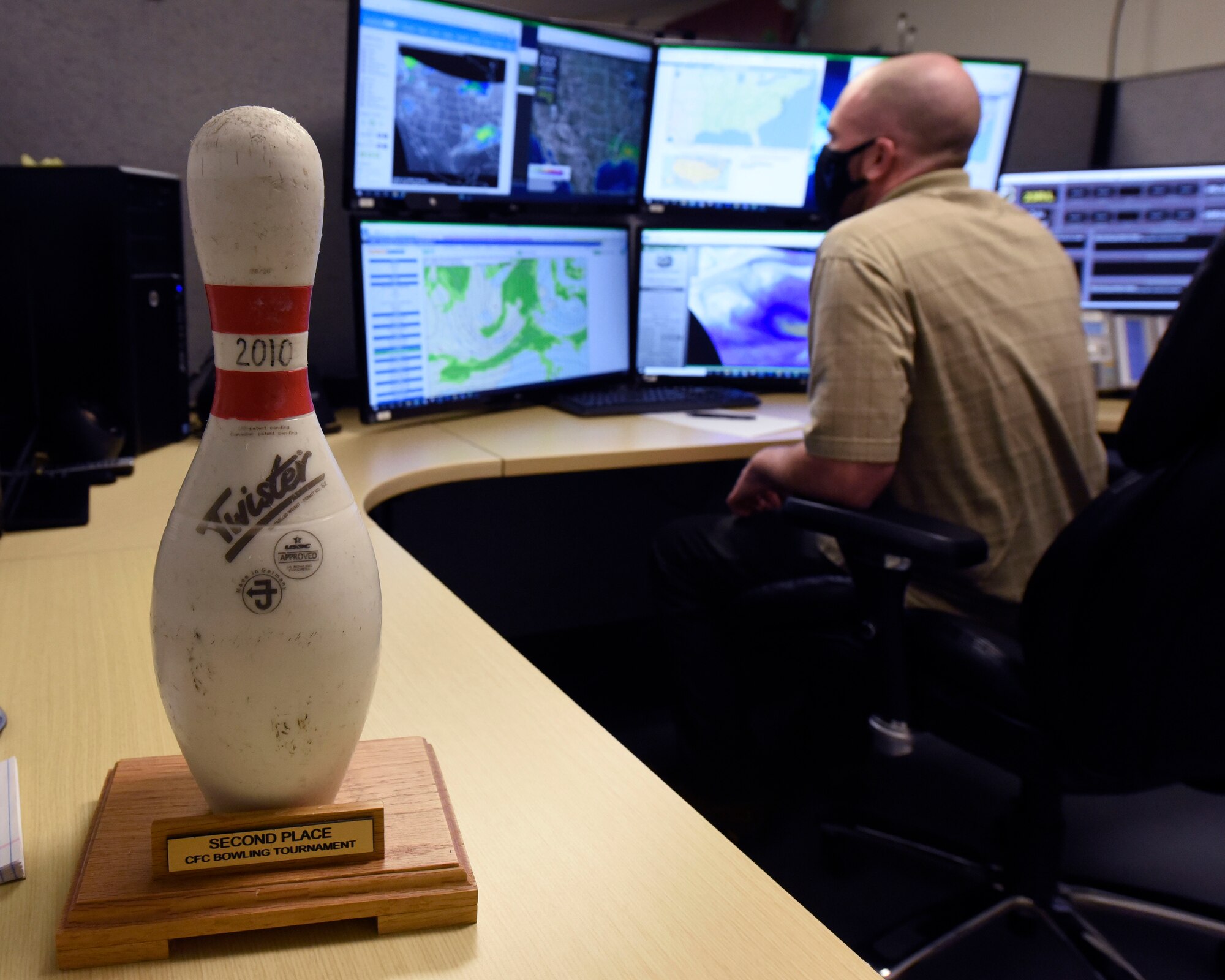 Air Force contractor Zach Grandin, an 88th Operations Support Squadron weather technician, studies forecasting models inside the Base Weather Station at Wright-Patterson Air Force Base, Ohio on March 2, 2021. Grandin is current bowling pin trophy holder for the most consistent, accurate forecasts. The Base Weather Station operates with ten contactors, around the clock and supports the aviation mission through briefs, observations and forecasts, and the resource protection mission through watches, warnings and advisories. (U.S. Air Force photo by Ty Greenlees)