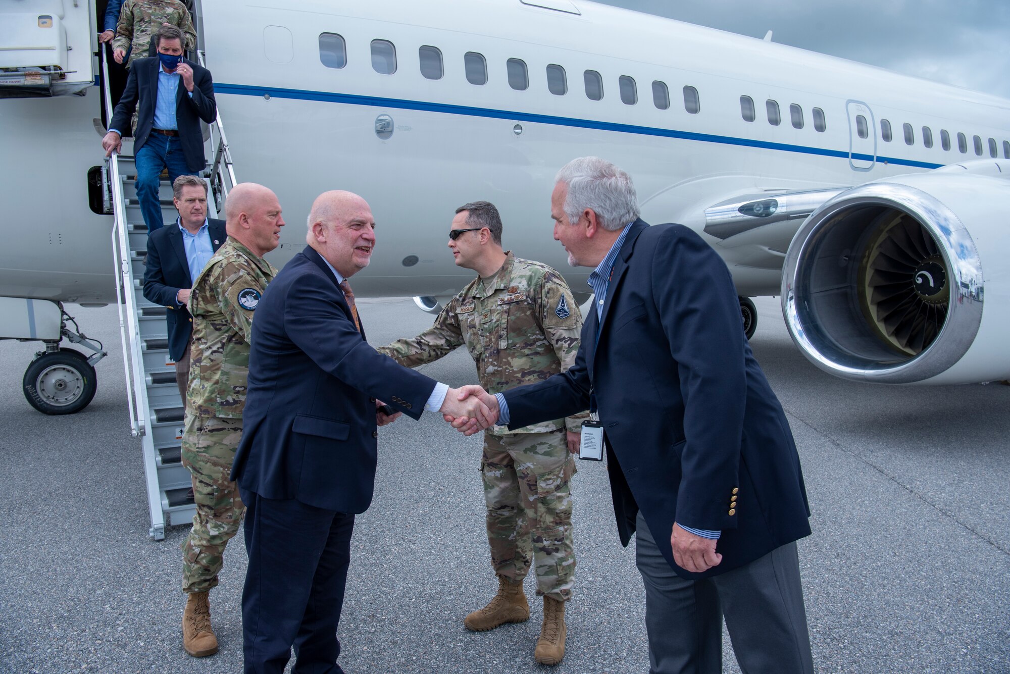 Acting Secretary of the Air Force John P. Roth, greets Scott Cook, Space Launch Delta 45 legislative liaison, as U.S. Space Force Gen. John W. “Jay” Raymond, Chief of Space Operations, greets U.S. Air Force Col. Ed Marshall, SLD 45 vice commander of support, after arriving at Cape Canaveral Space Force Station, Fla., May 17, 2021. Roth and Raymond visited the installation to meet with Airmen and Guardians supporting space launch operations and learn more about the partnerships between CCSFS and commercial companies. (U.S. Space Force photo by Tech. Sgt. James Hodgman)