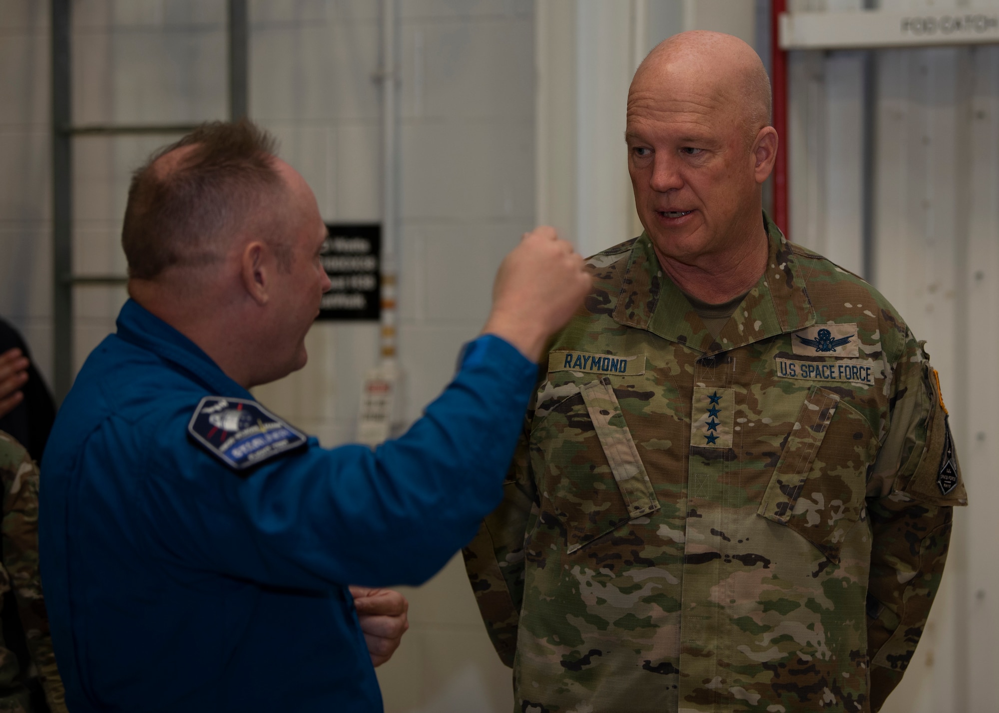 U.S. Space Force Gen. John W. "Jay" Raymond, right, Chief of Space Operations, speaks with NASA astronaut Mike Fincke, a retired U.S. Air Force colonel, during a tour of the Atlas Spaceflight Operations Center at Cape Canaveral Space Force Station, Fla., May 17, 2021. Raymond visited the installation to meet with Airmen and Guardians supporting space launch operations and learn more about the partnerships between CCSFS and commercial companies. (U.S. Space Force photo by Tech. Sgt. James Hodgman)