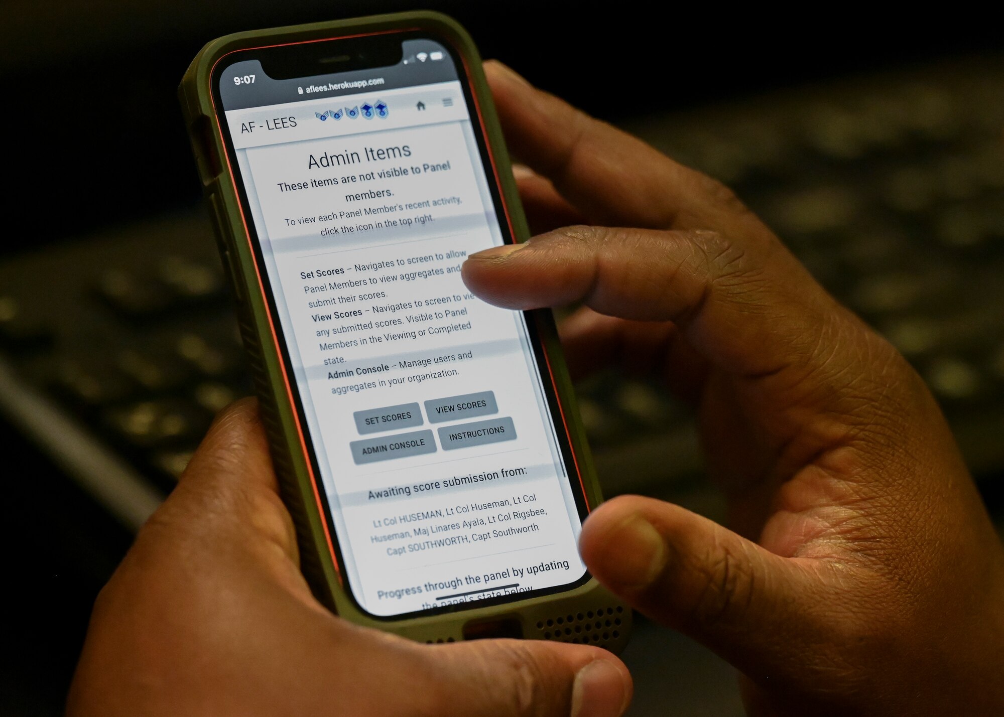 Tech. Sgt. Phillip E. Prather Jr. scrolls through an application on his phone.