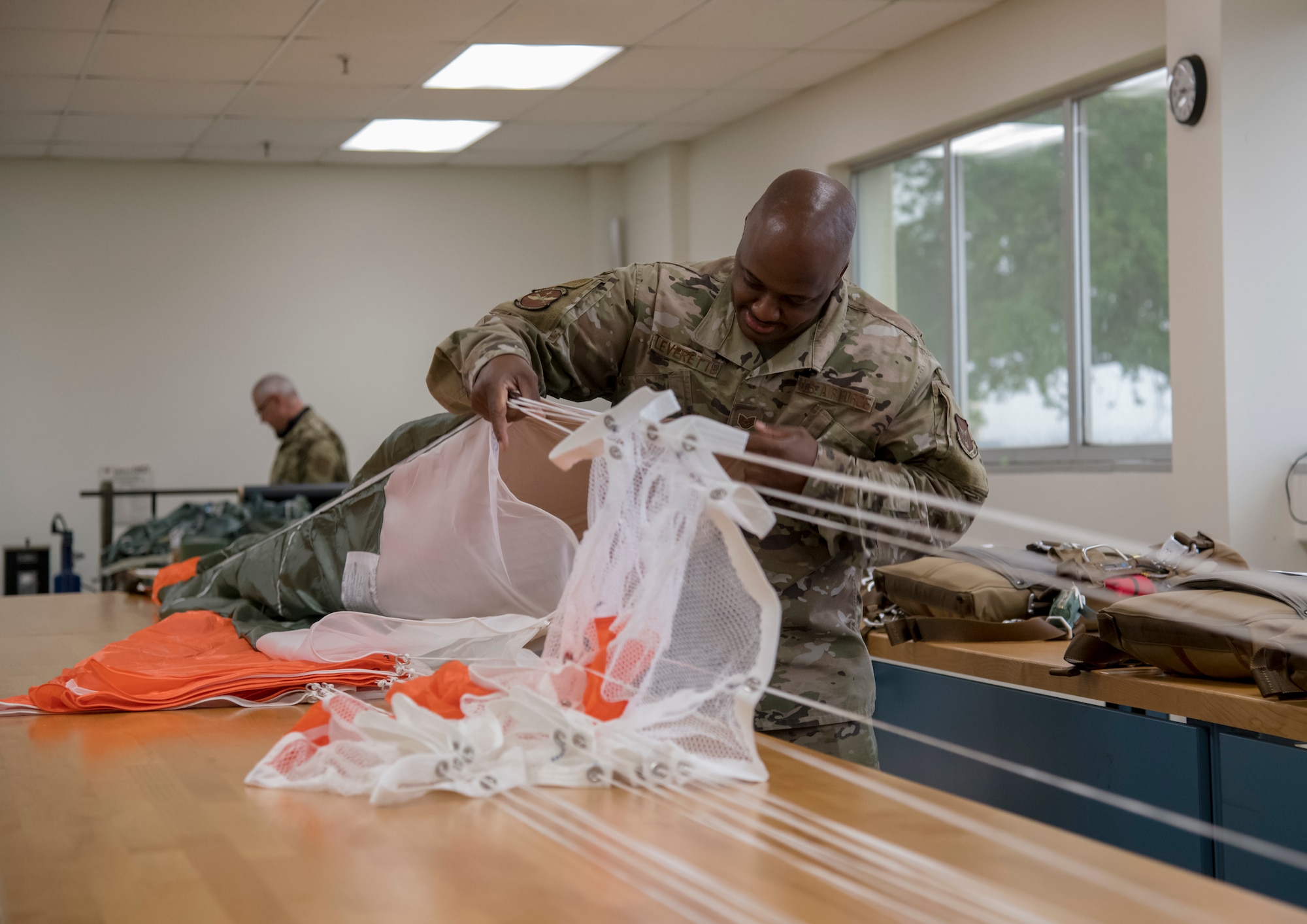 Tech. Sgt. Tyree Leverette, 403rd Operational Support Squadron aircrew flight equipment technician at Keesler Air Force Base, Miss., performs a continuity check on the canopy of a BA-30 Low Profile Parachute system May 2, 2021. The new parachute systems are on track to replace the BA-22s the 53rd Weather Reconnaissance Squadron WC-130Js use in time for the start of hurricane season in June. (U.S. Air Force by Staff Sgt. Kristen Pittman)