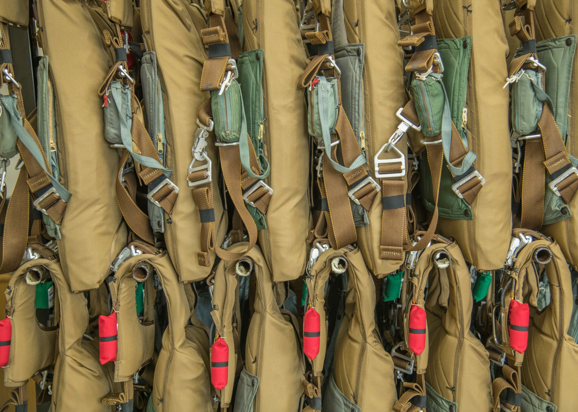 A multitude of BA-30 Low Profile Parachute systems hang in the 403rd Fabrication Flight building on Keesler Air Force Base, Miss., April 29, 2021. The 403rd Operations Support Squadron received 60 of these systems to replace the bulkier BA-22 parachute systems. (U.S. Air Force photo by Staff Sgt. Kristen Pittman)