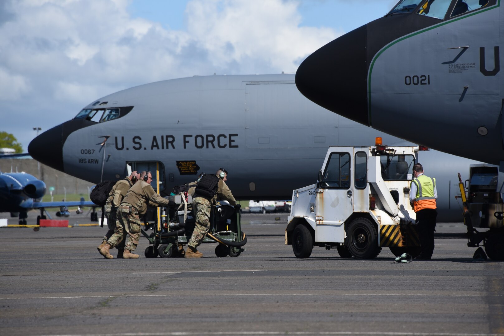 Airmen from the Iowa Air National Guard’s 185th Air Refueling Wing move a fuel system icing inhibitor cart in place to begin refueling a U.S. Air Force KC-135 on the flight line at the Glasgow Prestwick International Airport, Scotland, May 18, 2021. The portable fuel injection system is used to add deicing fuel additive during ground refueling. Air Guard Airmen and their refueling aircraft are in Scotland providing air refueling support as part of NATO exercise Formidable Shield.