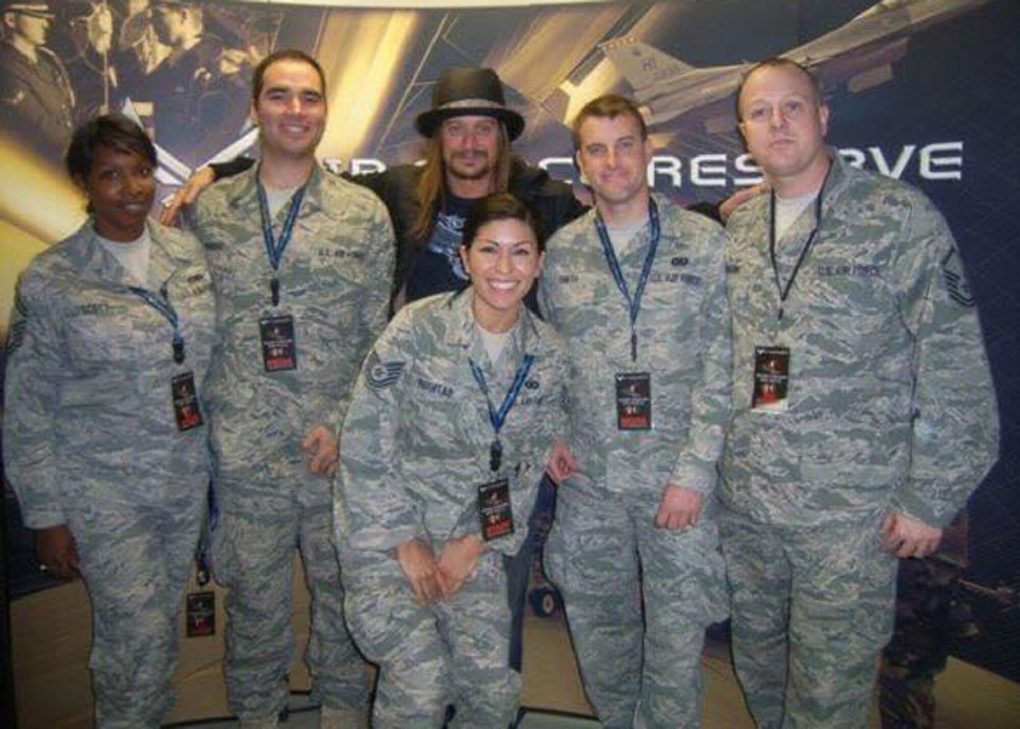 Chief Master Sgt. Michael Johnson (right), currently the Air Force Recruiting Service chief of strategic marketing, poses for a photo with Kid Rock before his Tour for the Troops concert at March Air Reserve Base, California, Dec. 11, 2010.