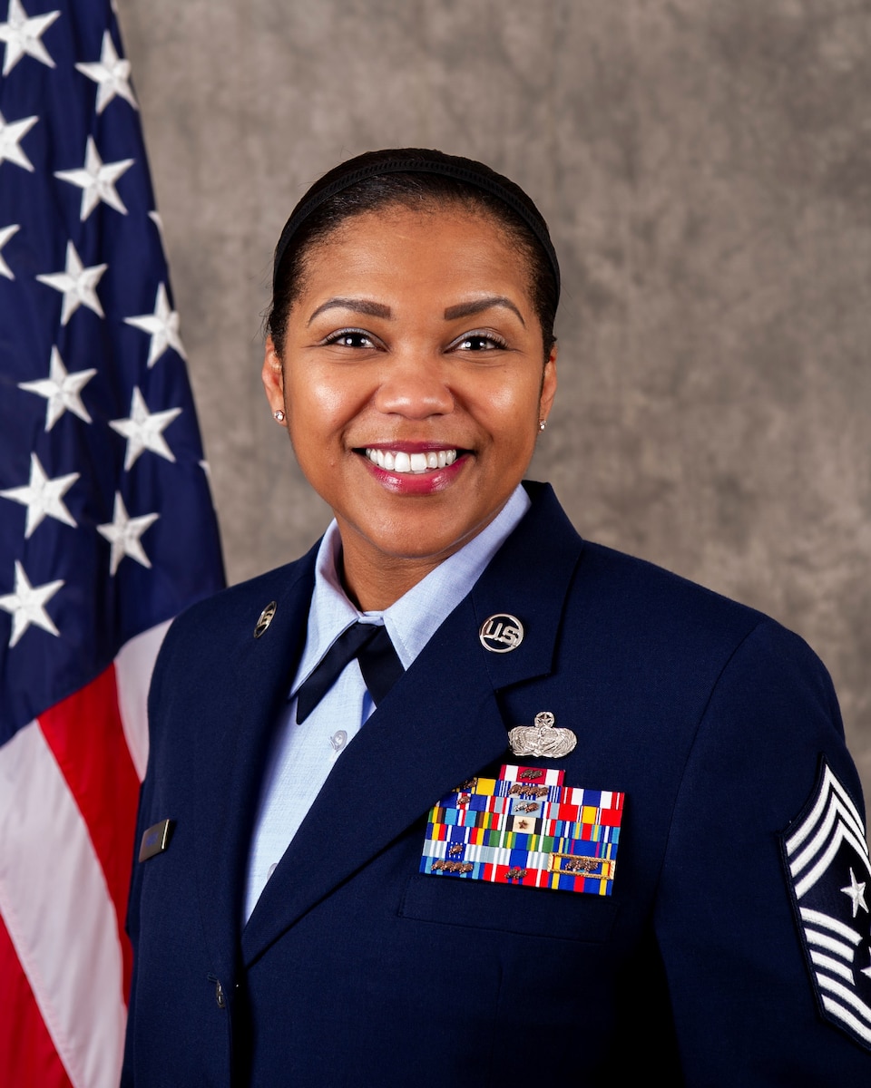 Chief Master Sgt. Adrienne Warren's official Air Force biography photo, looking at the camera in Air Force blues.