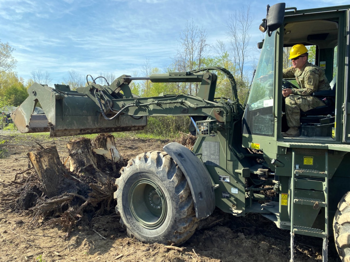 A New York Army National Guard Soldier assigned to the 152nd Engineer Company uses a dozer to clear tree trunks and debris at the National Guard Youngstown local training area in Youngstown, N.Y., May 15, 2021. The company returned to the field for collective training, constructing an Army Combat Fitness Course, a situational training exercise lanes course and a land navigation course.