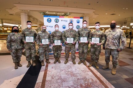 Col. Lisa J. Hou D.O., left, interim adjutant general, and State Command Sgt. Maj. Earnest Williams, right, with New Jersey Army National Guard Soldiers ,left to right, Spc. Kevin D. Tran, Headquarters and Headquarters Company, 1st Battalion, 114th Infantry Regiment; Staff Sgt. Manuel C. Rodriguez, Alpha Battery, 3rd Battalion, 112th Field Artillery; Staff Sgt. Matthew L. Rehl, Bravo Battery, 3rd Battalion, 112th Field Artillery; Pfc. Daniel E. Magay, Headquarters and Headquarters Company, 1st Battalion, 114th Infantry Regiment; Spc. Jason M. Vaccarella, Detachment 1, Headquarters Battery, 3rd Battalion, 112th Field Artillery, and Pfc. Daniel E. Magay, Headquarters and Headquarters Company, 1st Battalion, 114th Infantry Regiment, after a ceremony at the COVID-19 Burlington County vaccination site at Moorestown, N.J., May 19, 2021. The six Citizen-Soldiers with the 44th Infantry Brigade Combat Team aided a man who went into cardiac arrest at the site Feb. 15.