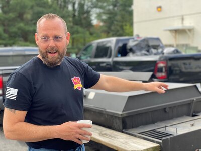 IMAGE: Tim White, executive director of Stafford Food Security, shows off a grill used to feed hundreds of people at community barbeques.