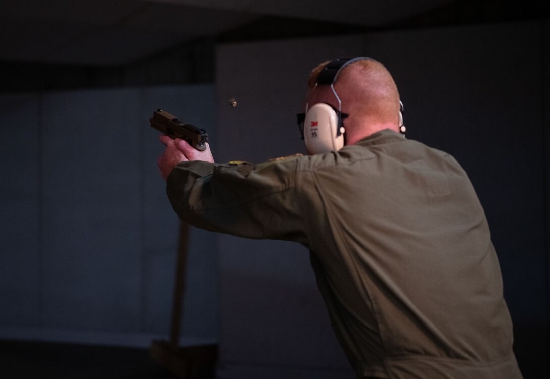 Capt. Kyle Byrd, a 37th Bomb Squadron pilot, fires an M-18 pistol during the National Police Week Excellence in Competition challenge at Ellsworth Air Force Base, S.D., May 12, 2021.