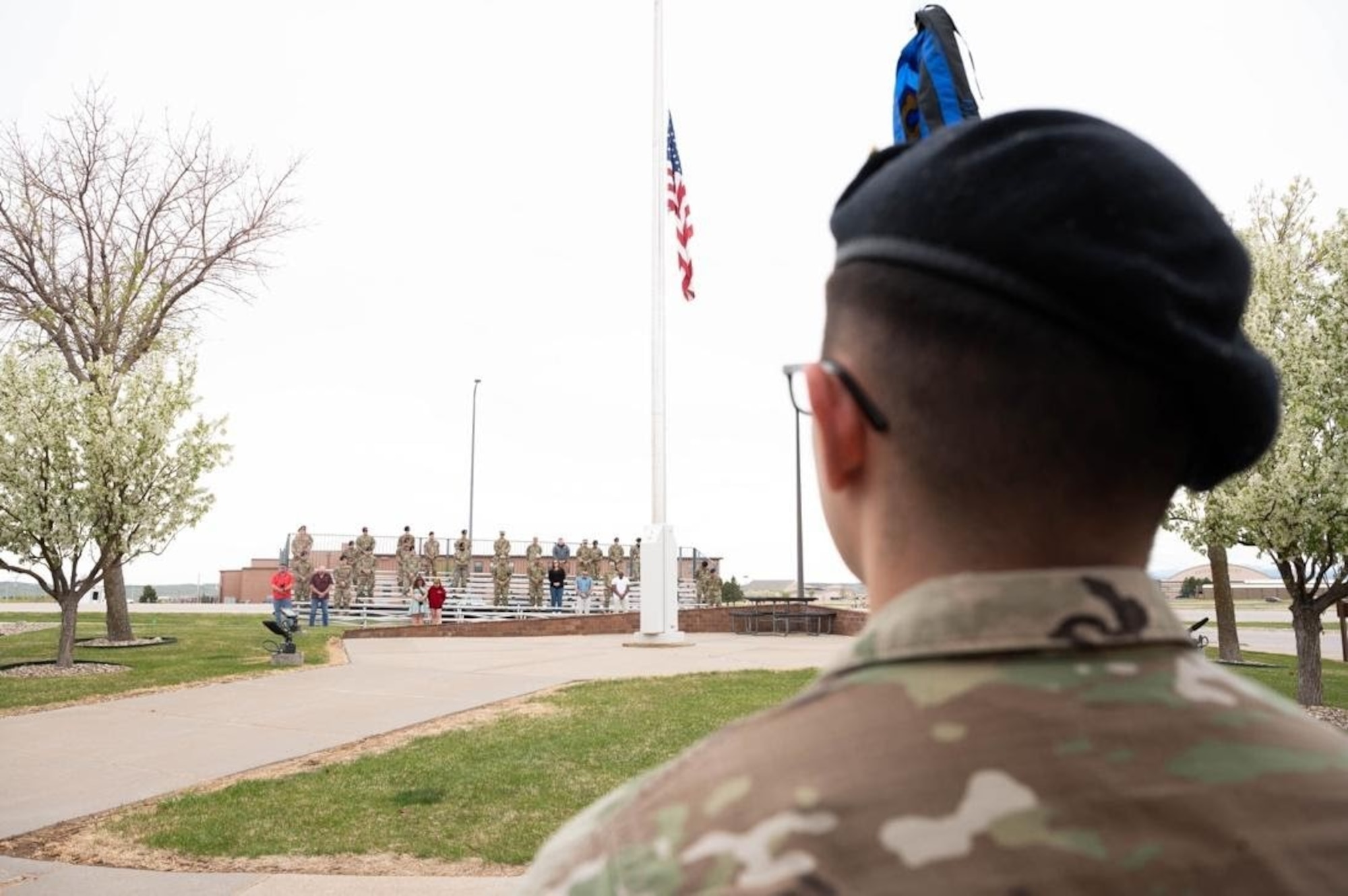 A defender from the 28th Security Forces Squadron pays respect to the flag and those who’ve served under it during a retreat ceremony at Ellsworth Air Force Base, S.D., May 14, 2021.