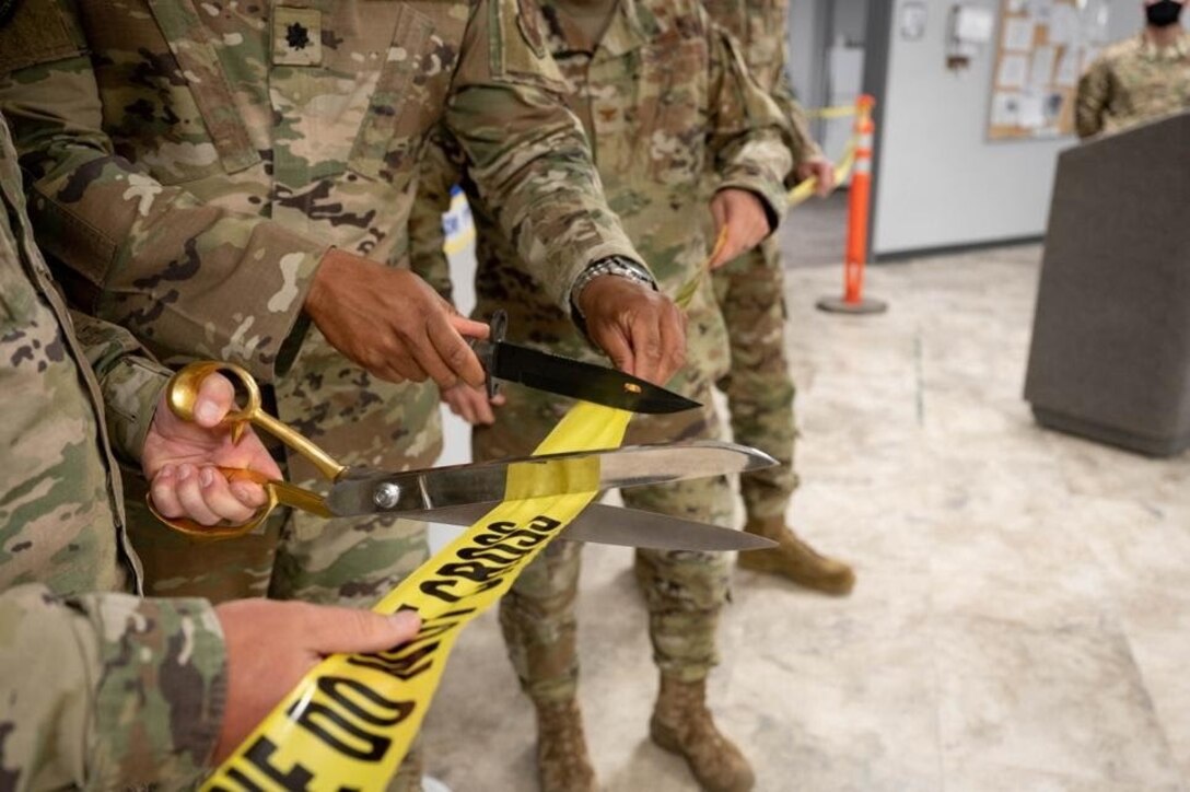 Base leadership cuts a ribbon to unveil the new 28th Security Forces Squadron gym at Ellsworth Air Force Base, S.D., May 10, 2021.