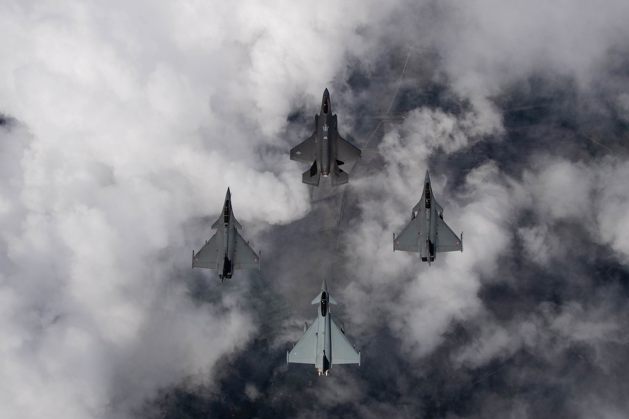Four aircraft fly in formation.