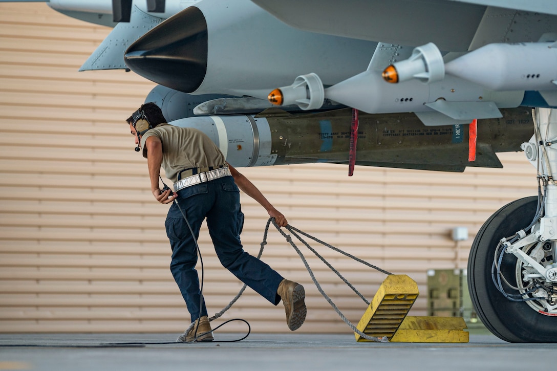 An airman works on an aircraft.