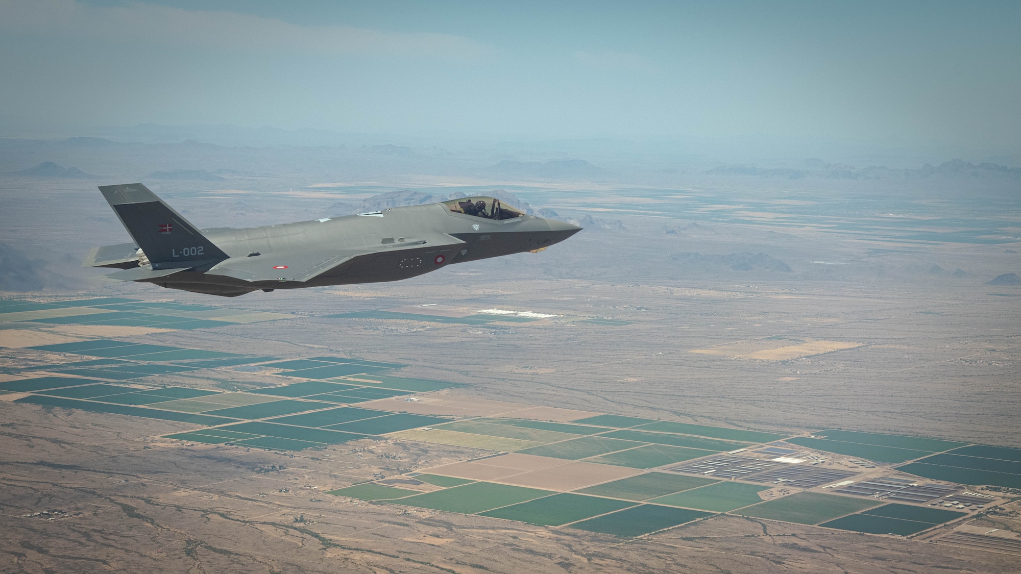 A Royal Danish Air Force F-35A Lightning II fighter jet assigned to the 308th Fighter Squadron at Luke Air Force Base soars over Bagdad, Arizona, May 5, 2021.
