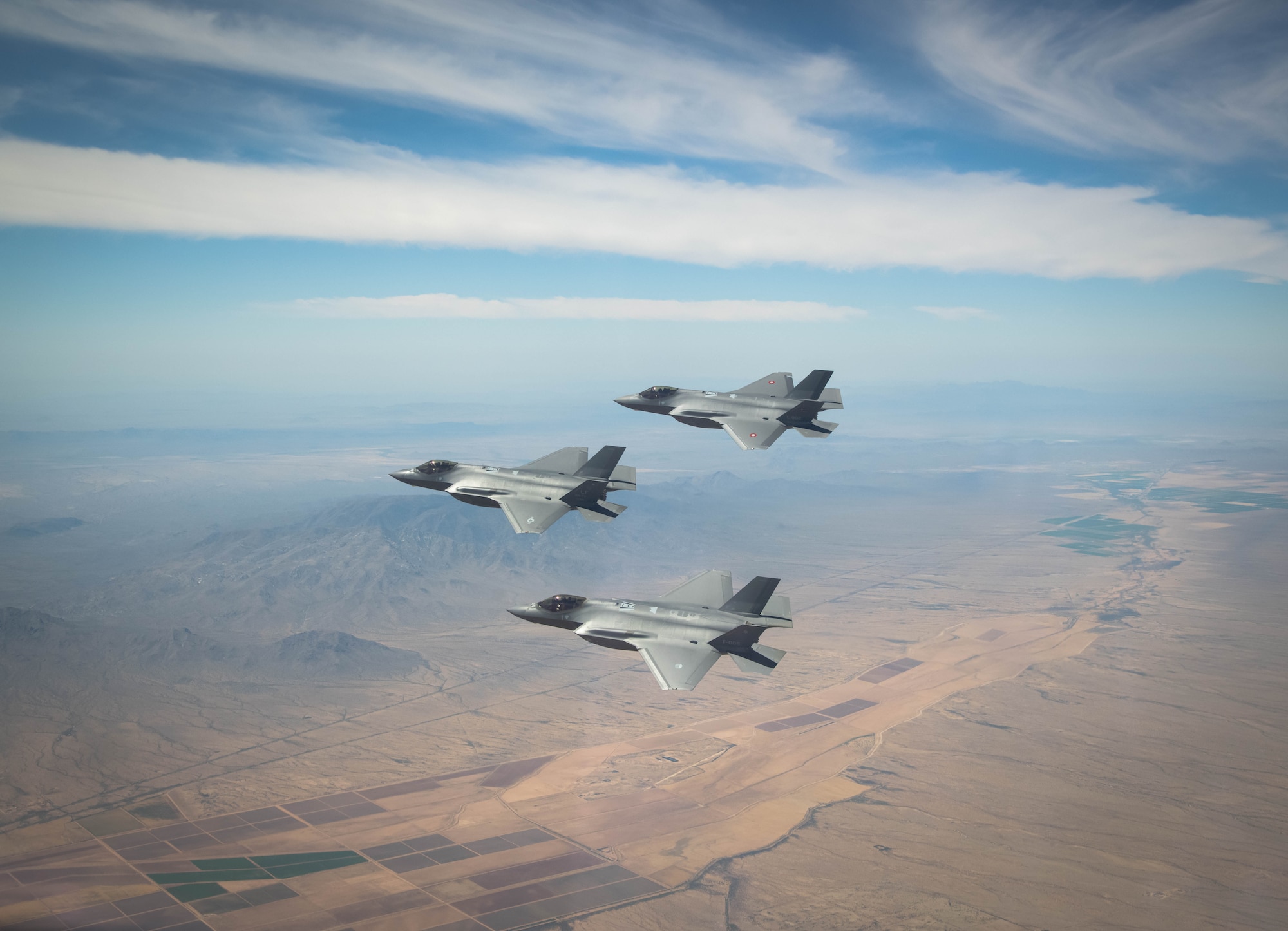 A U.S. Air Force, a Royal Danish Air Force and a Royal Netherlands Air Force F-35A Lightning II fighter jet assigned to the 308th Fighter Squadron, Luke Air Force Base, Arizona, fly in formation May 5, 2021, over Bagdad, Arizona.