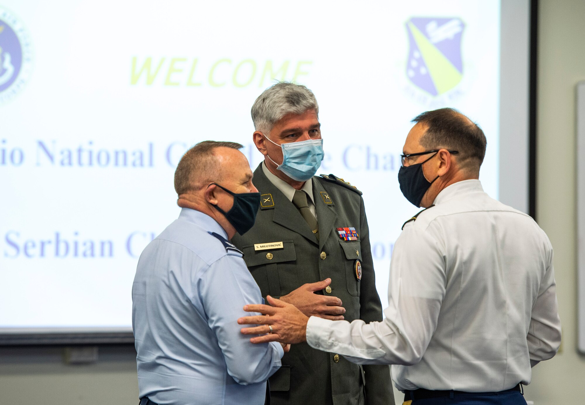 Col. Sasa Milutinovic, head of religious services for the Serbian armed forces (center), U.S. Air Force Col. Kim Bowen, 88th Air Base Wing chaplain (left) and Col. Daniel Burris, chaplain for the Ohio National Guard’s Special Troops Command talk before briefings begin in the Prairies Chapel Community Center at Wright-Patterson Air Force Base, Ohio, May 11, 2021. Milutinovic, along with four other Serbian chaplains, visited the base to hear how Wrigh-Patt chaplains take care of Airmen on a daily basis. (U.S. Air Force photo by Wesley Farnsworth)