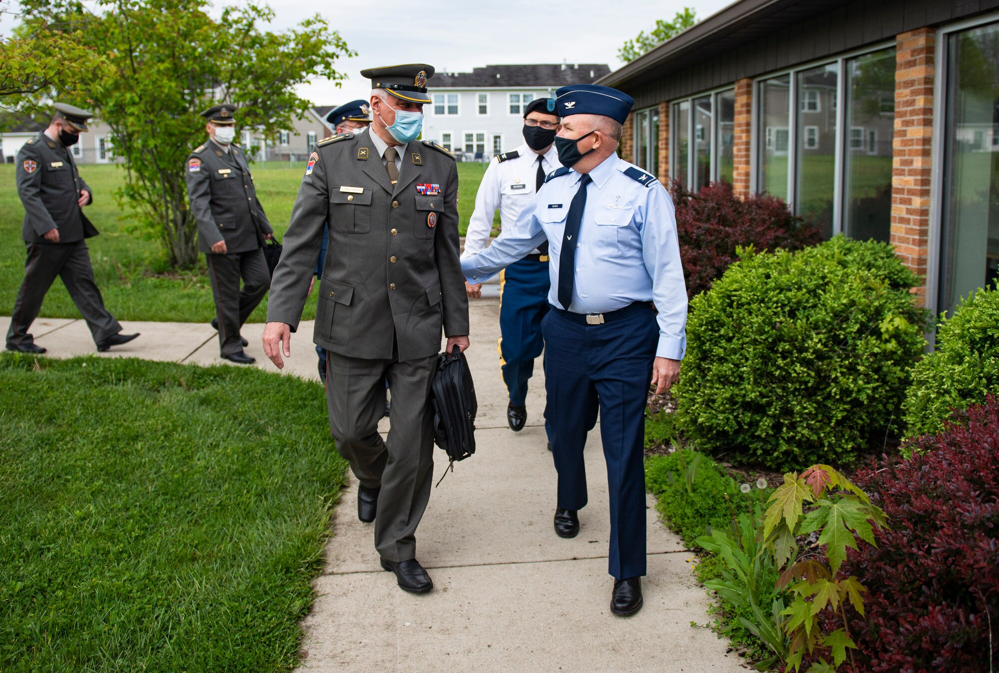 Col. Sasa Milutinovic, head of religious services for the Serbian Armed Forces, and Col. Kim Bowen, 88th Air Base Wing chaplain, talk as they walk into the Prairies Chapel Community Center at Wright-Patterson Air Force Base, Ohio, May 11, 2021. Milutinovic, along with four other Serbian chaplains, visited the base with Col. Daniel Burris, chaplain for the Ohio National Guard’s Special Troops Command, as well as others in the Ohio chaplain delegation. (U.S. Air Force Photo by Wesley Farnsworth)