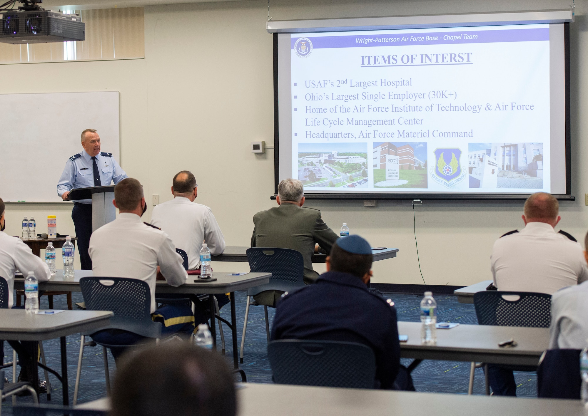 Col. Kim Bowen, 88th Air Base Wing chaplain, briefs five members of the Serbian Armed Forces chaplain delegation during their visit to Wright-Patterson Air Force Base, Ohio, May 11, 2021. The Serbian and Wright-Patt chaplains met to share how their chaplaincies take care of servicemembers on a daily basis. (U.S. Air Force photo by Wesley Farnsworth)