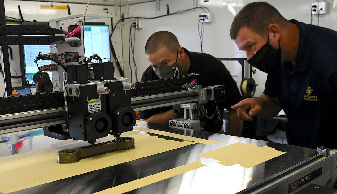 Robert Davies (left), project officer for Fabrication Equipment, from Marine Corps Systems Command, and Brian Long, Lead Developmental Tester for the Logistics Combat Engineer Systems portfolio, inspect the 3D printed all-purpose wrench during the testing and demonstration of the portable expeditionary fabrication lab, otherwise known as XFAB, on Camp Pendleton, Calif., April 5-9, 2021. The goal of the testing event was to integrate the Marine Corps Enterprise Network to determine what adjustments are needed before moving closer to the tentative delivery date to the Fleet Marine Forces in June 2022.