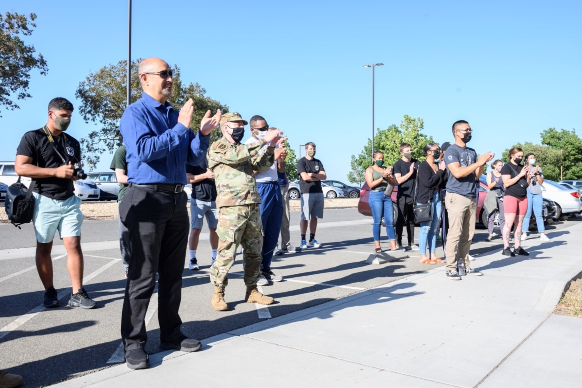 Members of Team Travis attend a ceremony commemorating the re-opening of the Peak Café May 19, 2021, at Travis Air Force Base, California. The Peak, a fixture at Travis AFB that gives Airmen living in the base’s dorms a place to meet and socialize, had previously been closed as a COVID-19 mitigation measure.