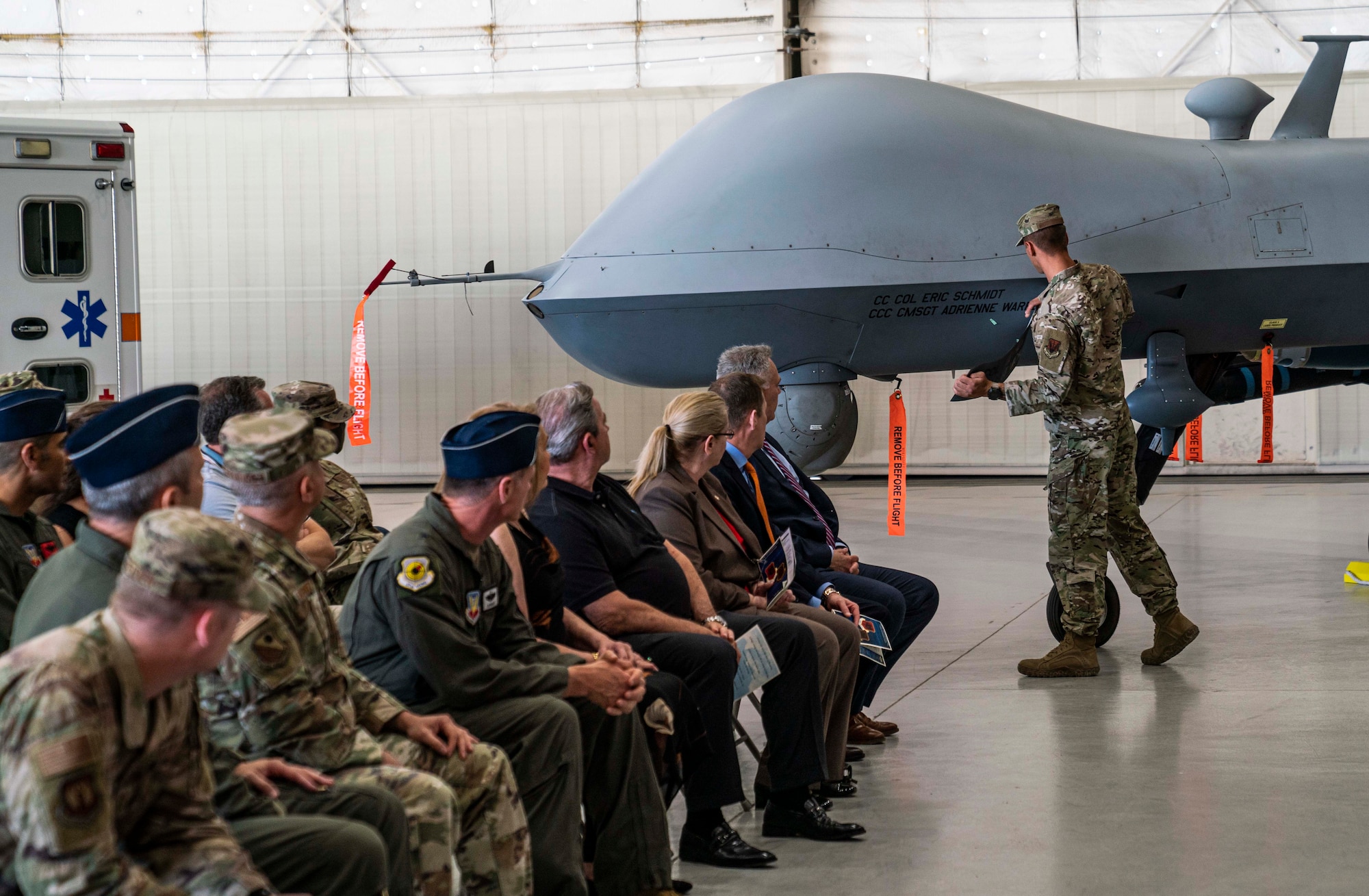 Senior Airman Levi unveils the name of the incoming 432nd Wing/432nd Air Expeditionary Wing commander and command Chief.