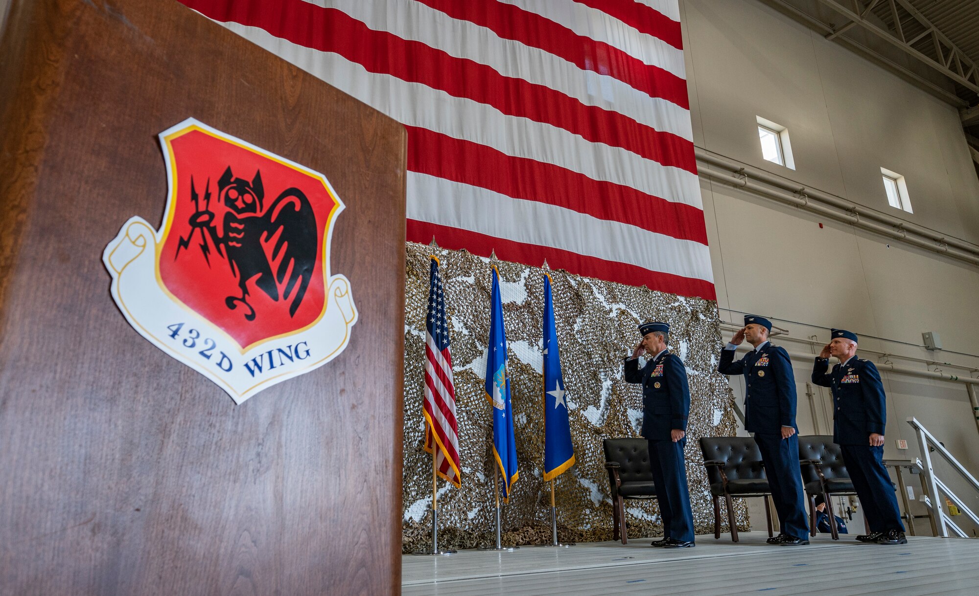Maj. General Chad P. Franks, Fifteenth Air Force commander, Col. Stephen Jones, outgoing 432nd Wing/432nd Air Expeditionary Wing commander, and Col. Eric Schmidt, incoming 432nd WG/432nd AEW commander salute the American flag during the national anthem during the 432nd WG/432nd AEW change of command ceremony at Creech Air Force Base, Nevada, May 20, 2021.