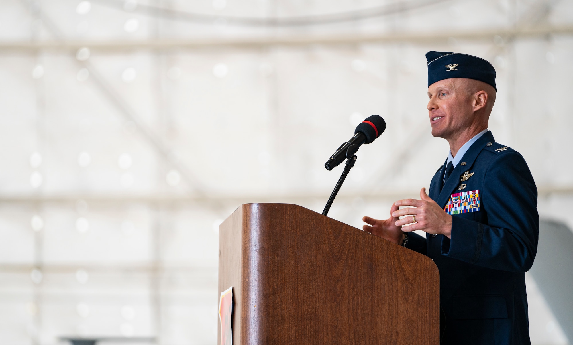 Col. Eric Schmidt, incoming 432nd Wing/432nd Air Expeditionary Wing commander, gives his remarks at a podium during the Wing change of command ceremony at Creech Air Force Base, Nevada, May 20, 2021.