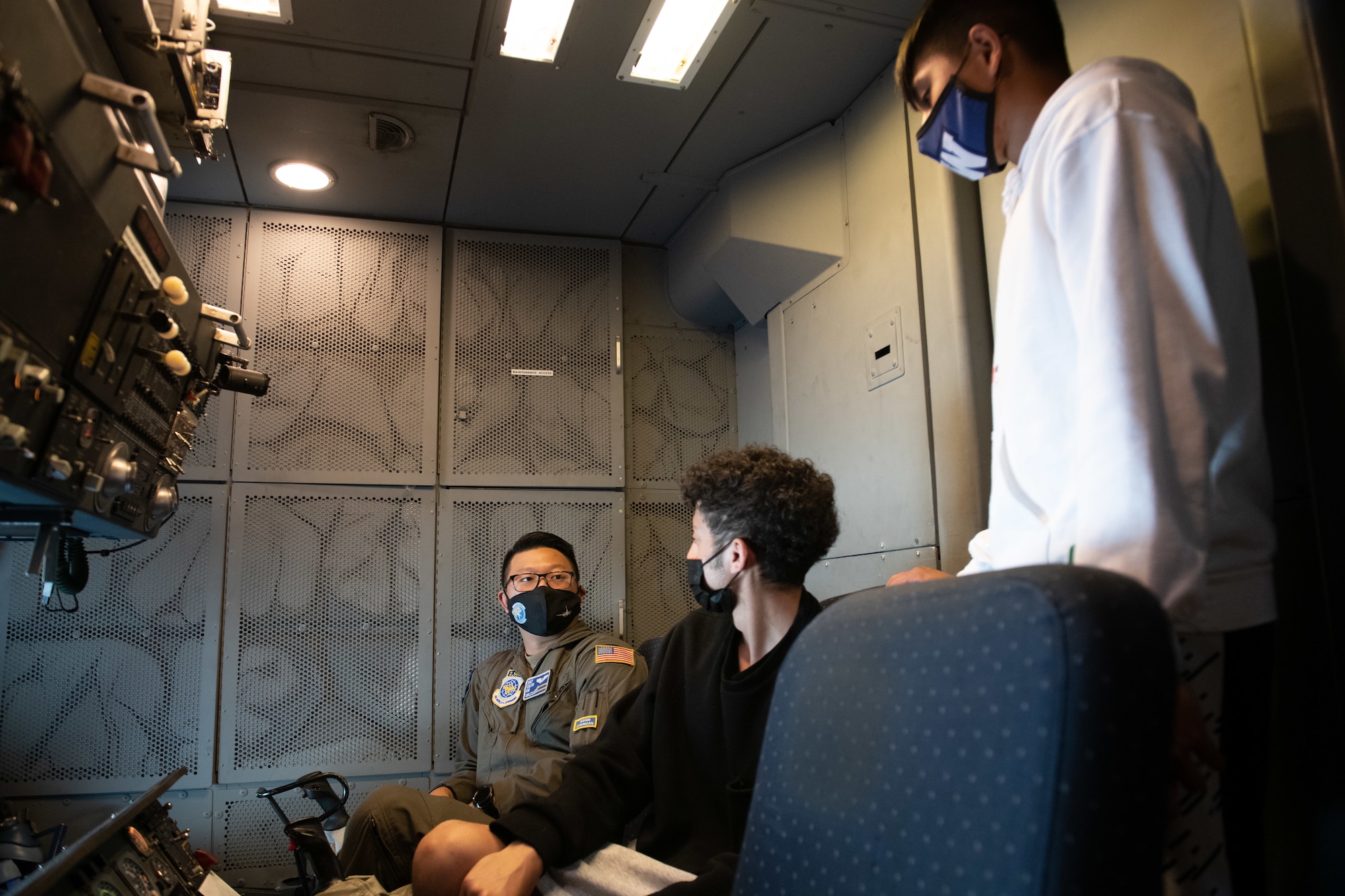 U.S. Air Force Airmen at the back of the boom operator compartment of a KC-10 Extender, speaks with two high school students May 15, 2021, at King County International Airport-Boeing Field, Seattle, Washington.