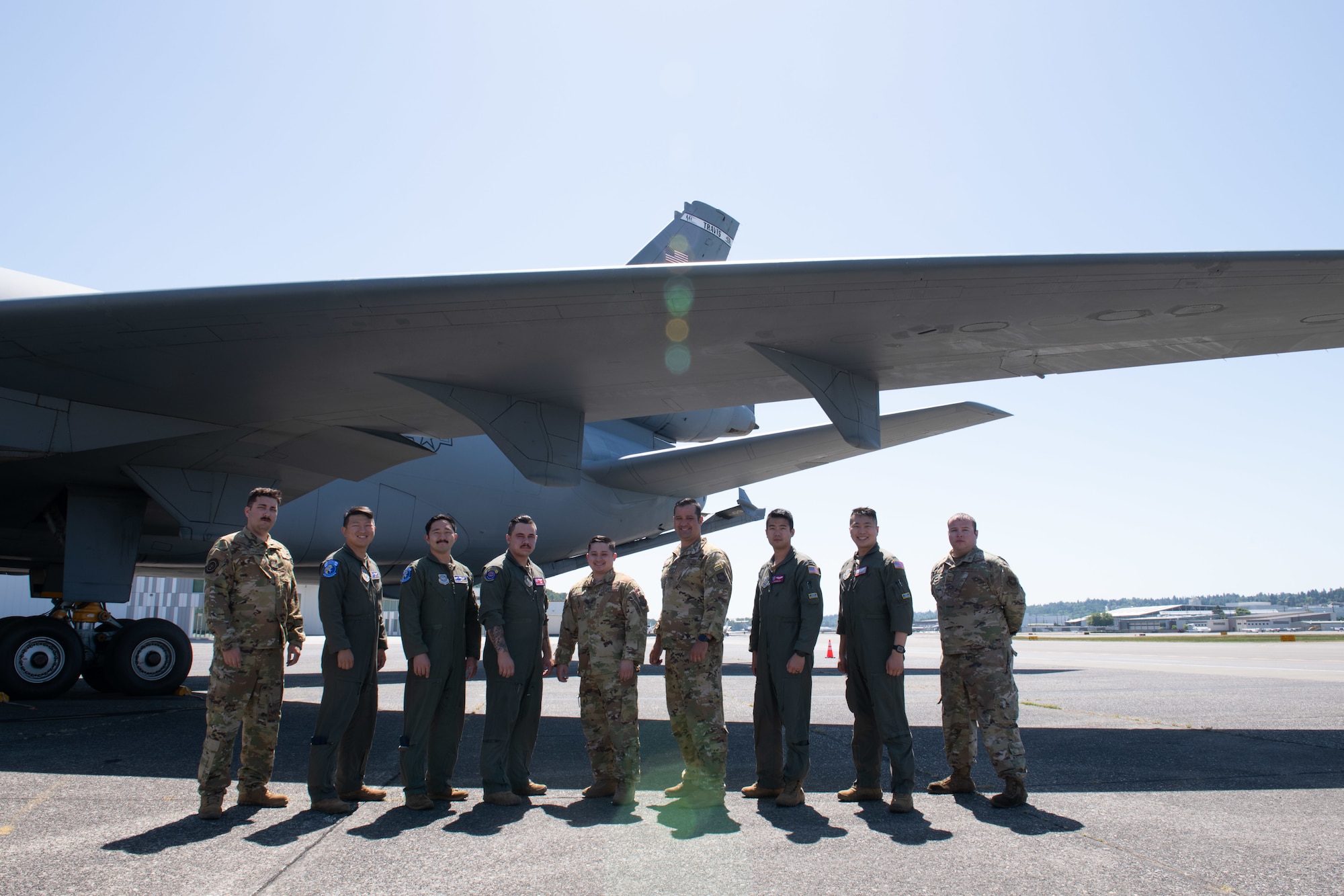 A U.S. Air Force aircrew of nine Airmen stand next to a KC-10 Extender May 16, 2021, at King County International Airport-Boeing Field, Seattle, Washington.
