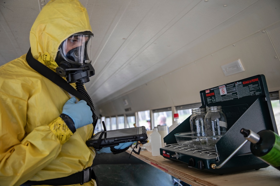 Staff Sgt. Logan Gladfeather, a survey team member of the 52nd Civil Support Team, Ohio National Guard, inspects a bus for dangerous and illicit substances at the Mat-Su Fire Training Center in Wasilla, Alaska, May 19, during Exercise ORCA 2021. ORCA is a chemical, biological, radioactive, nuclear threats response exercise designed for participants to provide support in the aftermath of hazardous materials incidents. ORCA tests interoperability between agencies, increases opportunities for working relationships, and practices requests for assistance methods. Approximately 250 National Guardsmen from CST units in Alaska, California, Connecticut, Colorado, Idaho, Ohio, Oregon, Rhode Island, South Carolina, South Dakota, Washington, and Wisconsin are in Alaska to participate in Exercise ORCA 2021. Numerous support units and civilian agencies participated in the exercise as well. (U.S. Army National Guard photo by Edward Eagerton)