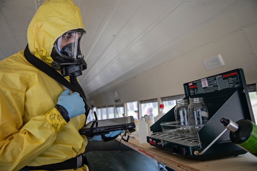 Staff Sgt. Logan Gladfeather, a survey team member of the 52nd Civil Support Team, Ohio National Guard, inspects a bus for dangerous and illicit substances at the Mat-Su Fire Training Center in Wasilla, Alaska, May 19, during Exercise ORCA 2021. ORCA is a chemical, biological, radioactive, nuclear threats response exercise designed for participants to provide support in the aftermath of hazardous materials incidents. ORCA tests interoperability between agencies, increases opportunities for working relationships, and practices requests for assistance methods. Approximately 250 National Guardsmen from CST units in Alaska, California, Connecticut, Colorado, Idaho, Ohio, Oregon, Rhode Island, South Carolina, South Dakota, Washington, and Wisconsin are in Alaska to participate in Exercise ORCA 2021. Numerous support units and civilian agencies participated in the exercise as well. (U.S. Army National Guard photo by Edward Eagerton)