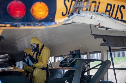 Staff Sgt. Logan Gladfeather and Tech. Sgt. David Hurst, team members of the 52nd Civil Support Team, Ohio National Guard, survey a bus at the Mat-Su Fire Training Center in Wasilla, Alaska, May 19, during Exercise ORCA 2021. ORCA is a chemical, biological, radioactive, nuclear threats response exercise designed for participants to provide support in the aftermath of hazardous materials incidents. ORCA tests interoperability between agencies, increases opportunities for working relationships, and practices requests for assistance methods. Approximately 250 National Guardsmen from CST units in Alaska, California, Connecticut, Colorado, Idaho, Ohio, Oregon, Rhode Island, South Carolina, South Dakota, Washington, and Wisconsin are in Alaska to participate in Exercise ORCA 2021. Numerous support units and civilian agencies participated in the exercise as well. (U.S. Army National Guard photo by Edward Eagerton)