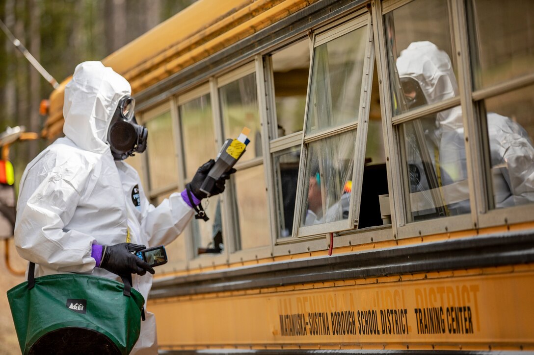 Sgt. 1st Class Andrew Markham, reconnaissance noncommissioned officer in charge, 10th Civil Support Team, Washington National Guard, surveys a bus at the Mat-Su Fire Training Center in Wasilla, Alaska, May 19, during Exercise ORCA 2021. ORCA is a chemical, biological, radioactive, nuclear threats response exercise designed for participants to provide support in the aftermath of hazardous materials incidents. ORCA tests interoperability between agencies, increases opportunities for working relationships, and practices requests for assistance methods. Approximately 250 National Guardsmen from CST units in Alaska, California, Connecticut, Colorado, Idaho, Ohio, Oregon, Rhode Island, South Carolina, South Dakota, Washington, and Wisconsin are in Alaska to participate in Exercise ORCA 2021. Numerous support units and civilian agencies participated in the exercise as well. (U.S. Army National Guard photo by Edward Eagerton)