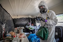 Sgt. 1st Class Andrew Markham, reconnaissance noncommissioned officer in charge, 10th Civil Support Team, Washington National Guard, inspects a bus for dangerous and illicit substance production at the Mat-Su Fire Training Center in Wasilla, Alaska, May 19, during Exercise ORCA 2021. ORCA is a chemical, biological, radioactive, nuclear threats response exercise designed for participants to provide support in the aftermath of hazardous materials incidents. ORCA tests interoperability between agencies, increases opportunities for working relationships, and practices requests for assistance methods. Approximately 250 National Guardsmen from CST units in Alaska, California, Connecticut, Colorado, Idaho, Ohio, Oregon, Rhode Island, South Carolina, South Dakota, Washington, and Wisconsin are in Alaska to participate in Exercise ORCA 2021. Numerous support units and civilian agencies participated in the exercise as well. (U.S. Army National Guard photo by Edward Eagerton)