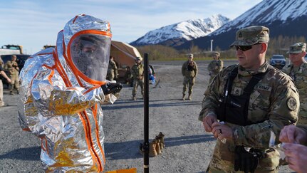 Sgt. 1st Class Brian Miller, 102nd Civil Support Team, Oregon National Guard, senior supply noncommissioned officer, supervises the decontamination process after a team member responded to a simulated incident at the Alaska Railroad train yard in Seward, Alaska, May 18, in support of Exercise ORCA 21. ORCA is a chemical, biological, radioactive, nuclear threats response exercise designed for participants to provide support in the aftermath of hazardous materials incidents. ORCA tests interoperability between agencies, increases opportunities for working relationships, and practices requests for assistance methods. Approximately 250 National Guardsmen from CST units in Alaska, California, Connecticut, Colorado, Idaho, Ohio, Oregon, Rhode Island, South Carolina, South Dakota, Washington, and Wisconsin are in Alaska to participate in Exercise ORCA 2021. Numerous support units and civilian agencies participated in the exercise as well. (U.S. Army National Guard photo by Dana Rosso)